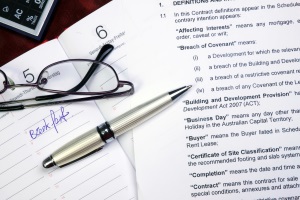 image of pen, glasses, and a stack of paper